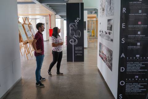 Dos estudiantes viendo la exposición, en la planta baja del CIM.